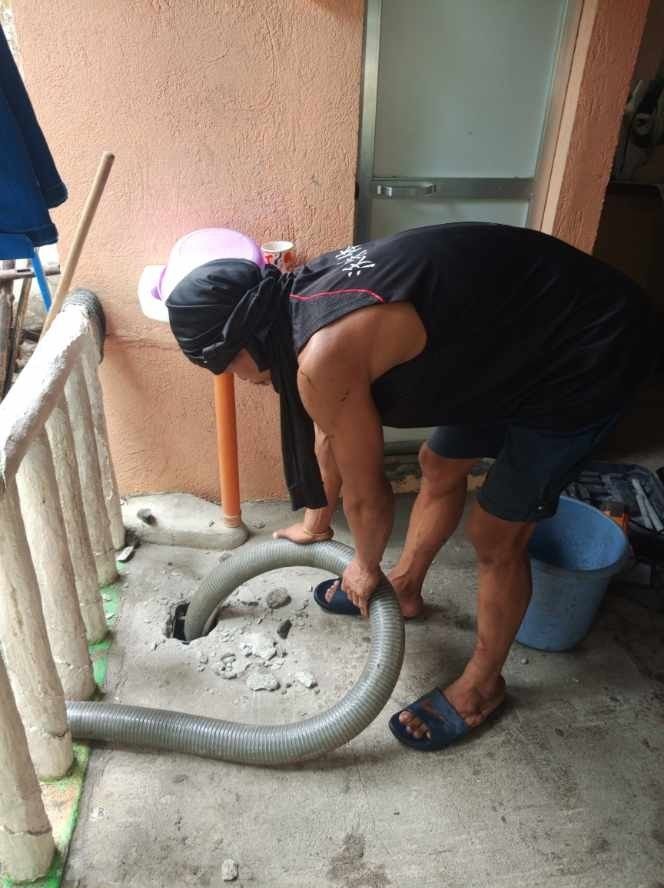 Worker completing siphoning job